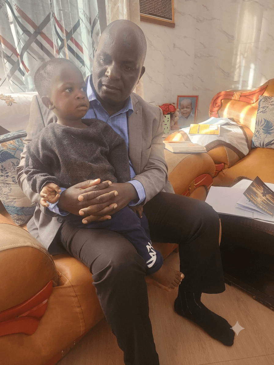 A child UPSDE has cared for since birth, held by a UPSDE representative